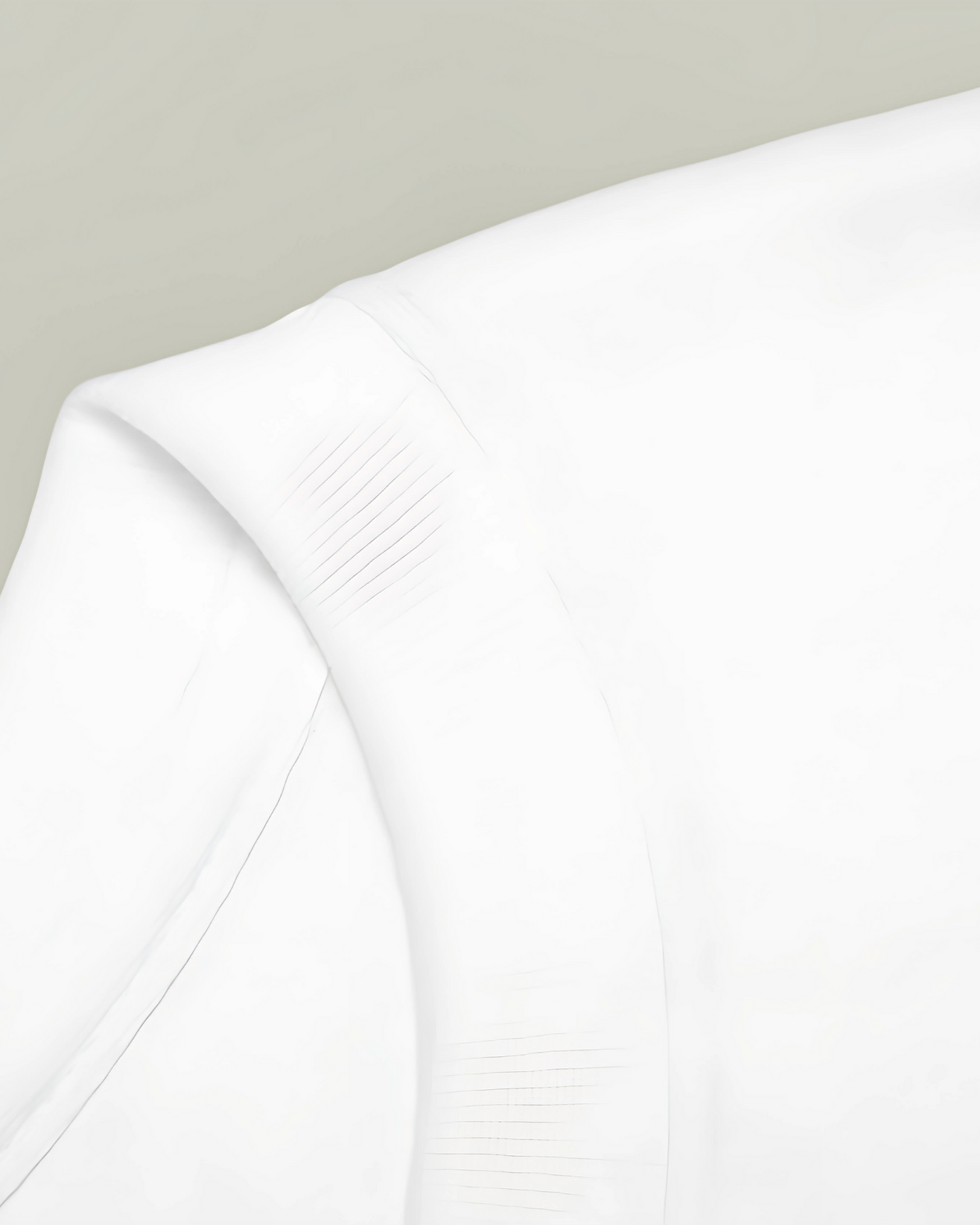 Close-up of a white fabric texture on a light gray background