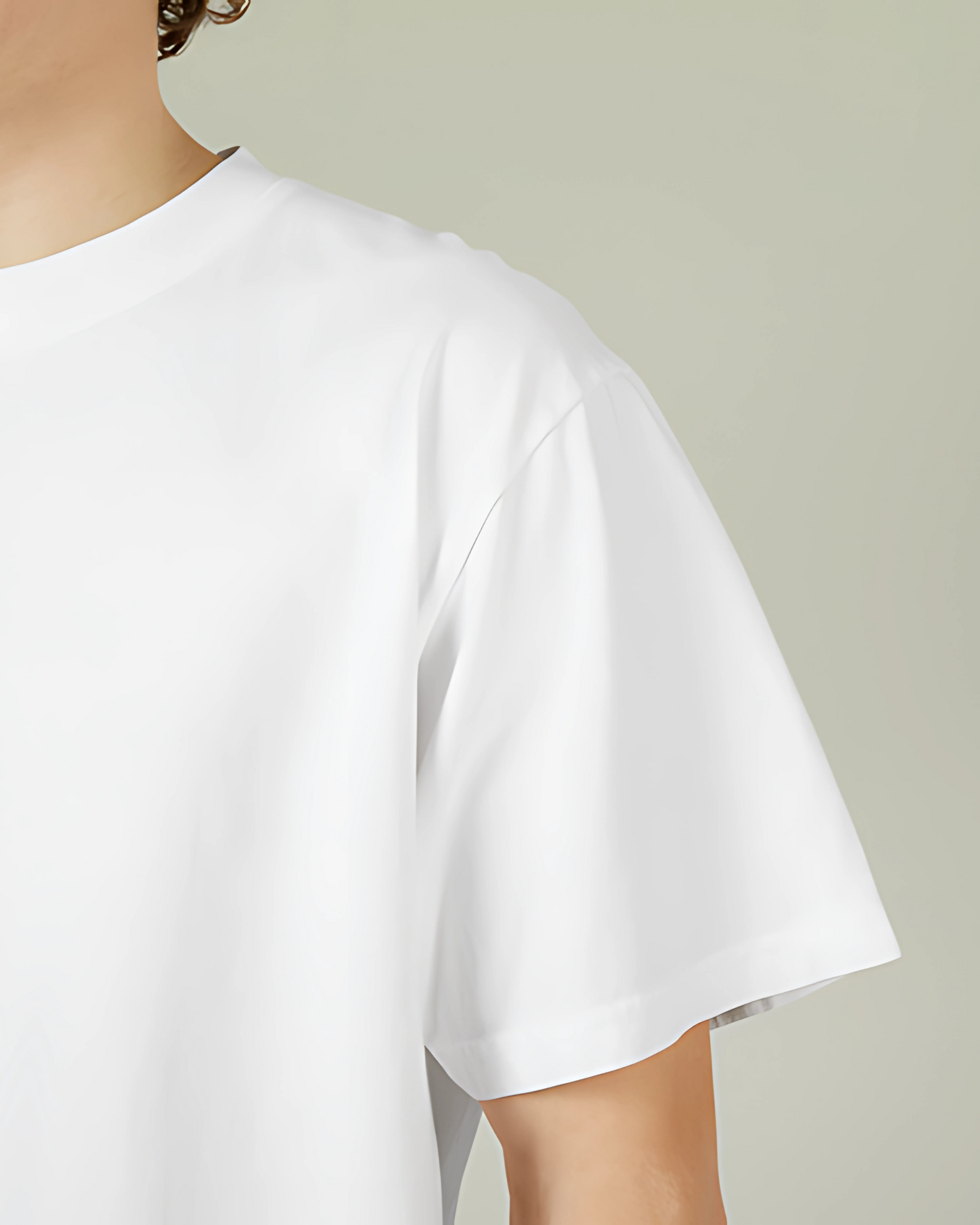 White t-shirt worn by a person on a plain background