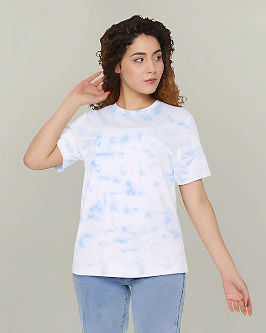 Person wearing a white tie-dye t-shirt against a plain background