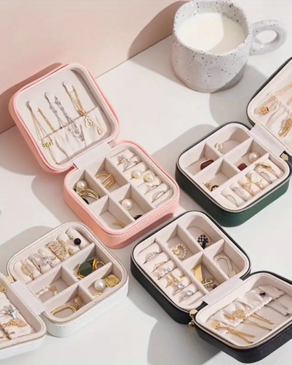 Set of jewelry cases with various earrings on a light surface.