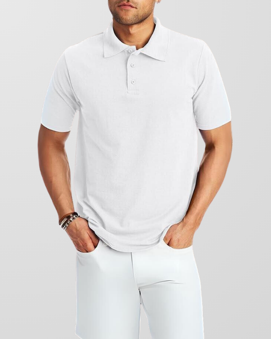 A man wearing a white customized polo shirt with short sleeves, standing with hands in pockets.